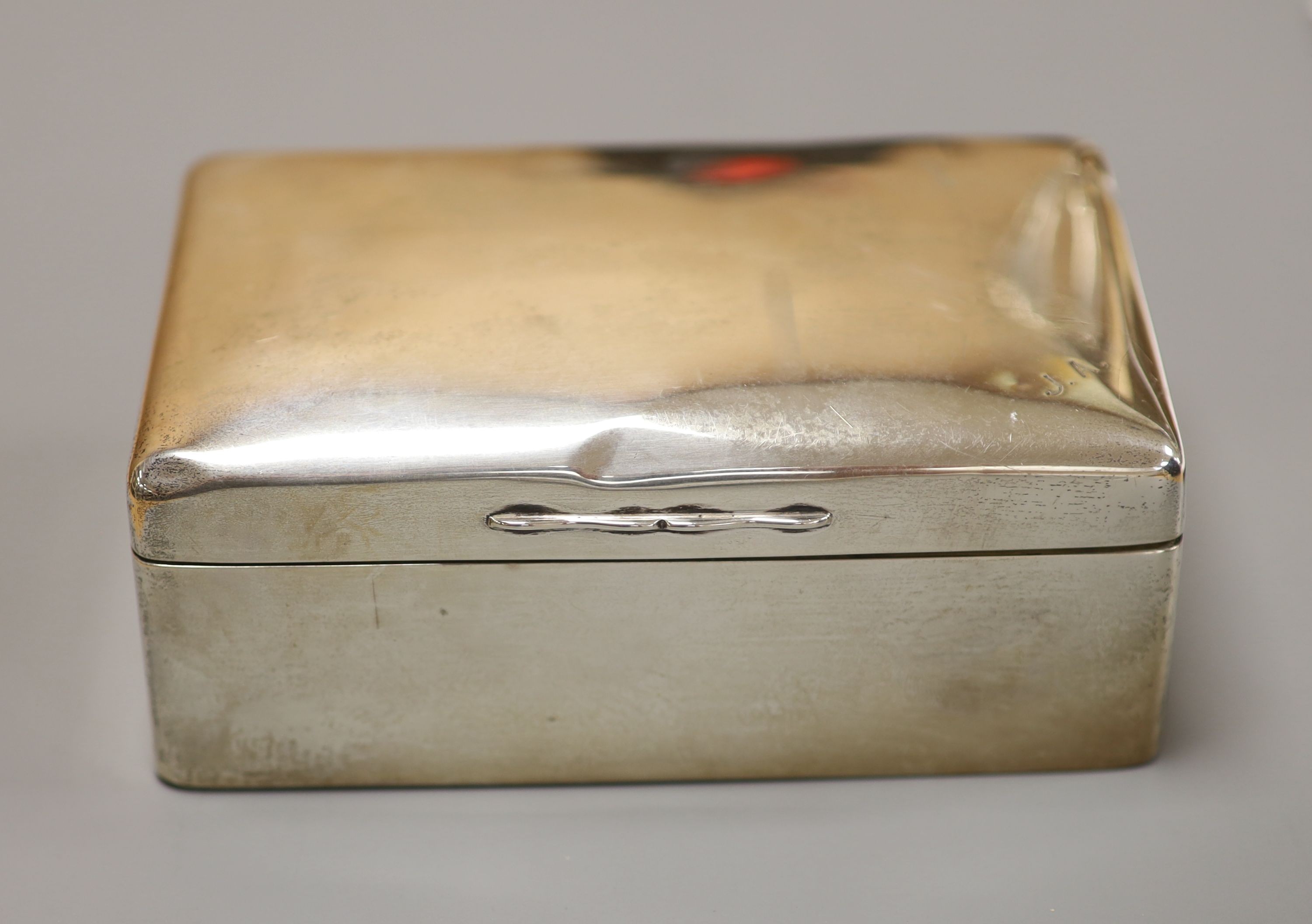 Three silver mounted cigarette cases, largest 17.9cm.